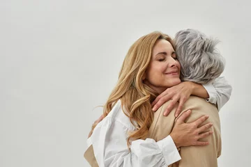 Foto op Plexiglas Loving adult daughter embrace old mother feel grateful © Svitlana