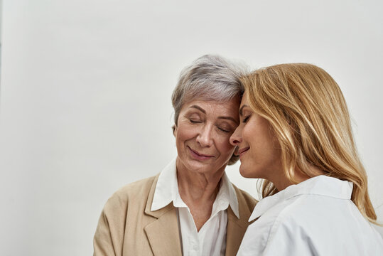 Loving grownup daughter and old mother tender moment