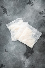 Rice basmati in portion bags, on gray stone table background, top view flat lay, with copy space for text