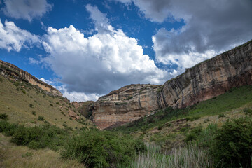 Landscape scene of sandstone rocks mountains and a sky with clouds
