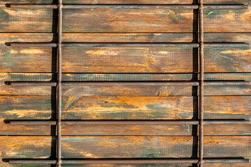 Metal bars in front of wooden surface  