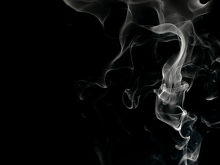 Fototapeta premium Chaotic mixing smoke creates abstract patterns on a black background
