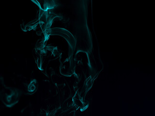 Fototapeta premium Chaotic mixing smoke creates abstract patterns on a black background