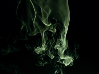 Fototapeta premium Chaotic mixing smoke creates abstract patterns on a black background