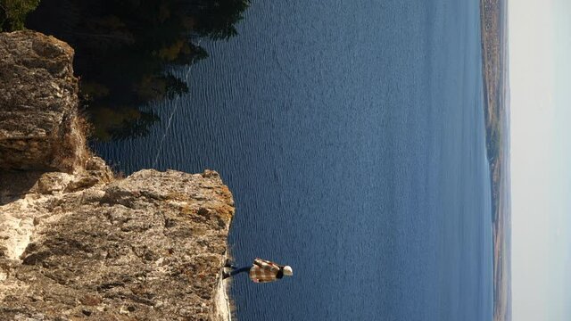 A girl walks in the mountains and admires a beautiful view