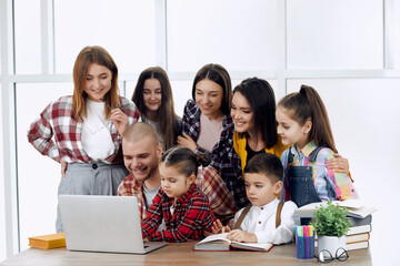 Whole family working together on homework happily in one room. Exited.
