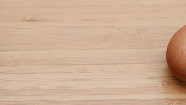 Slide shot of video 4k and full HD of quality healthy organic egg with eggshell isolated on clean background.

