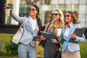 Portrait of three smiling business people outdoors