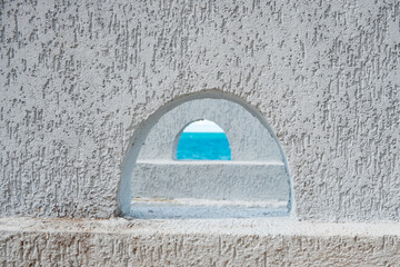 sea view through small semicircular windows one through the other