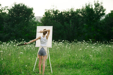 artist in nature painting a picture creative landscape back view