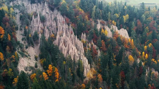 Aerial view on natural earth pyramids in autumn Dolomite Alps. Renon, Ritten, Dolomites, South Tyrol, Italy. UHD 4k drone video
