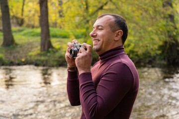 stylish young man with a camera