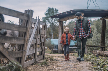 Farmer and his daughetr walking together hand in hand