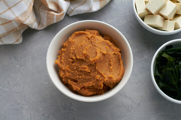 miso paste shiro miso in a bowl on grey background for miso soup with tofu wakame seaweed