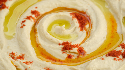 Hummus with smoked paprika and olive oil close up. Healthy vegan food