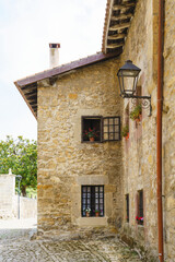 Vertical view of typical spanish stone house in Cantabria. Panoramic view of ancient picturesque city of Santillana del Mar. Travel and holidays backgrounds in Spain.