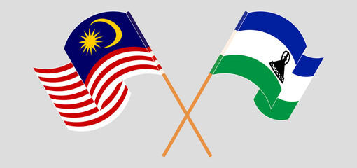 Crossed and waving flags of Malaysia and Kingdom of Lesotho