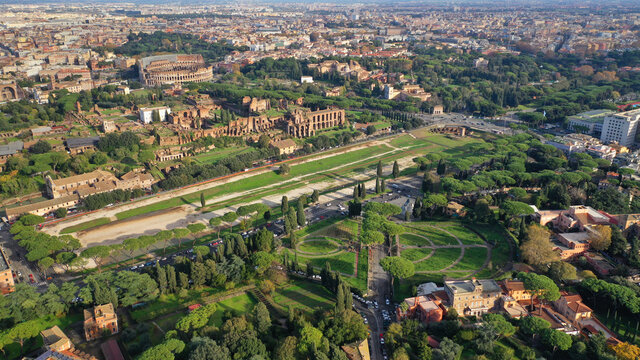 Aerial drone photo of iconic Circus Maximus a green space and remains of a stone - marble arena used for chariot races built next to Palatine hill and world famous Colosseum, historic Rome, Italy