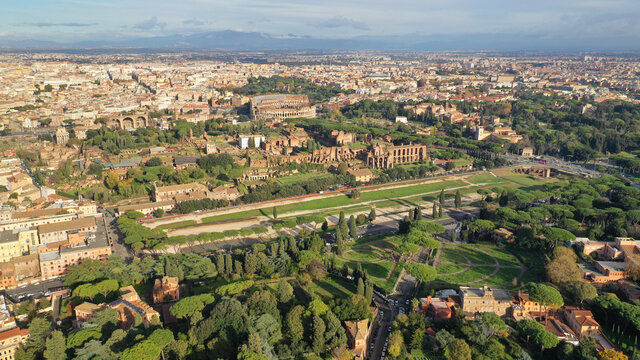 Aerial drone photo of iconic Circus Maximus a green space and remains of a stone - marble arena used for chariot races built next to Palatine hill and world famous Colosseum, historic Rome, Italy