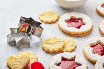Classic Linzer Christmas Cookies with raspberry or strawberry jam on light background.
