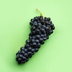Cluster of grapes on a flat green background