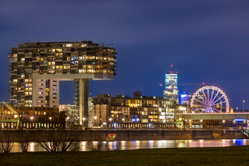Fototapeta premium Illuminated buildings against Cologne winter skyline