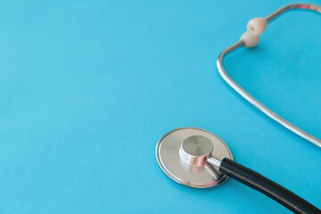 Medical stethoscope on a blue background. Copy space.
