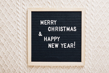 Christmas flatlay letter board spelling Merry Christmas and Happy New Year