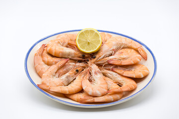 plate of cooked prawns on white background