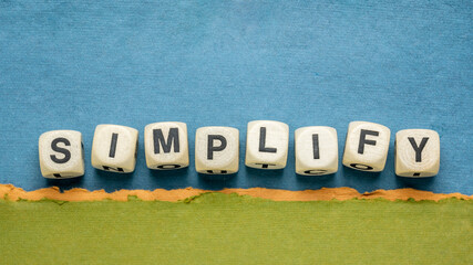 simplify reminder, pragmatic, declutter or get organized concept,  - wooden dices on a handmade...