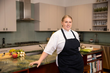 Portrait of Chef Megan Gill in home kitchen looking at camera