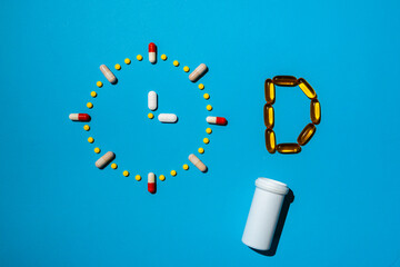 D vitamin with a clock made from pills, concept of a healthy lifestyle with an additional supplement for a healthy lifestyle.