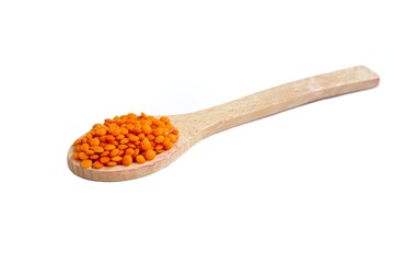 Red lentils in a spoon isolated on white background
