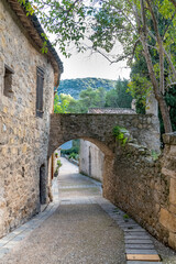 Fototapeta na wymiar Saint-Guilhem-le-Desert in France, view of the village, typical street and houses 