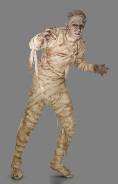 Portrait of a person dressed as a mummy for Halloween, wrapped in bandages slowly moving towards camera with arms out, against gray background