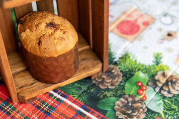 Obraz na płótnie Canvas Panettone in wooden box on table with Christmas tablecloth.