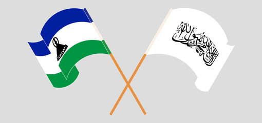 Crossed and waving flags of Kingdom of Lesotho and Taliban