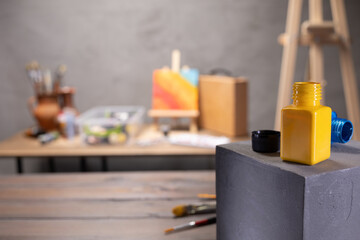 Paint brush and artist tools with cube on wood table. Paintbrush art painter supplies on desk