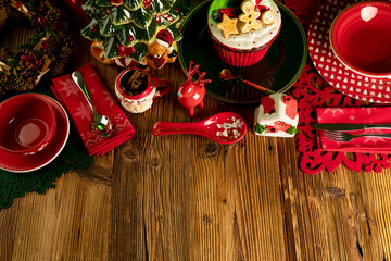 Christmas background. Christmas tableware and decorations on rustic wooden table.