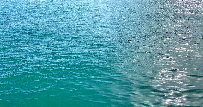 Beautiful blue glittering seascape. Turquoise ocean shiny waves.