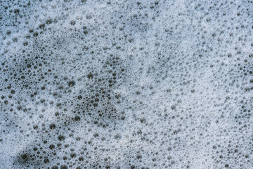 sea foam with abstract texture of air bubbles as natural background