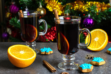 two glasses with hot mulled wine orange and cinnamon