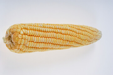 Organic corn cob isolated on white background.
