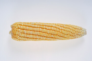 Organic corn cob isolated on white background.