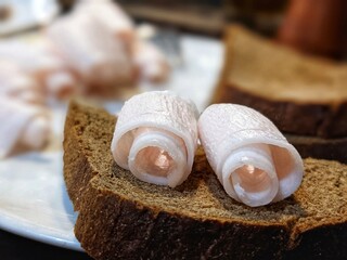 Fototapeta na wymiar Rye bread and lard on a plate. A popular snack in Ukraine. National Lard Day.