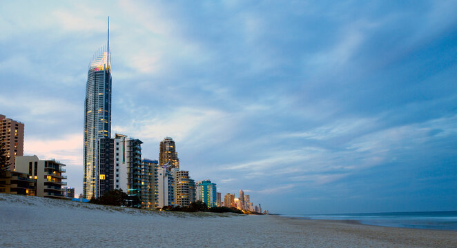 Resorts and apartments lining the edge of Surfers Paradise beach in the early evening