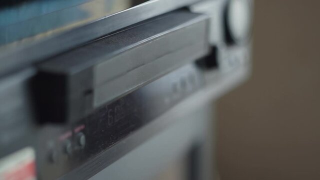 A Video Cassette Leaves The Tape Recorder. Handheld Shooting. Shallow Depth Of Field, Bokeh. Day, Room