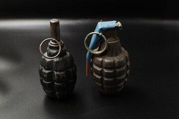 Naklejka na ściany i meble Russian and american grenades on black background