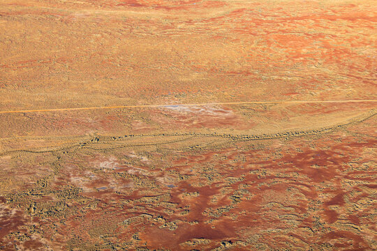Aerial birds eye view of dry arid landscape from central South Australia. Aerial images over the Painted Desert, Dry Creek Beds, and scrub bushland