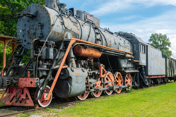 Fototapeta na wymiar Ancient steam locomotive at railway station in summer, Haapsalu, Estonia 